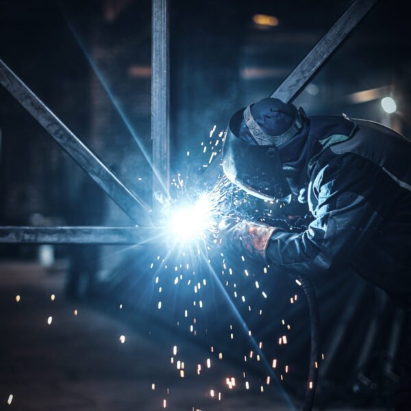 Welding work with metal construction at busy metal factory