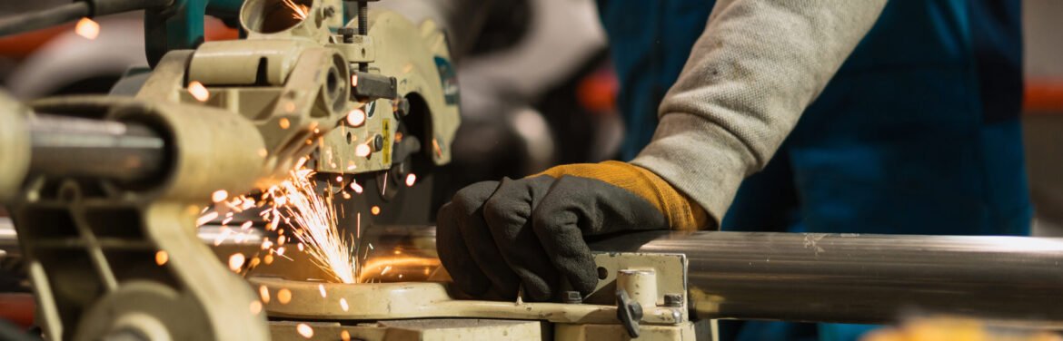 Technician worker cutting metal with many sharp sparks. Using equipments to cat iron